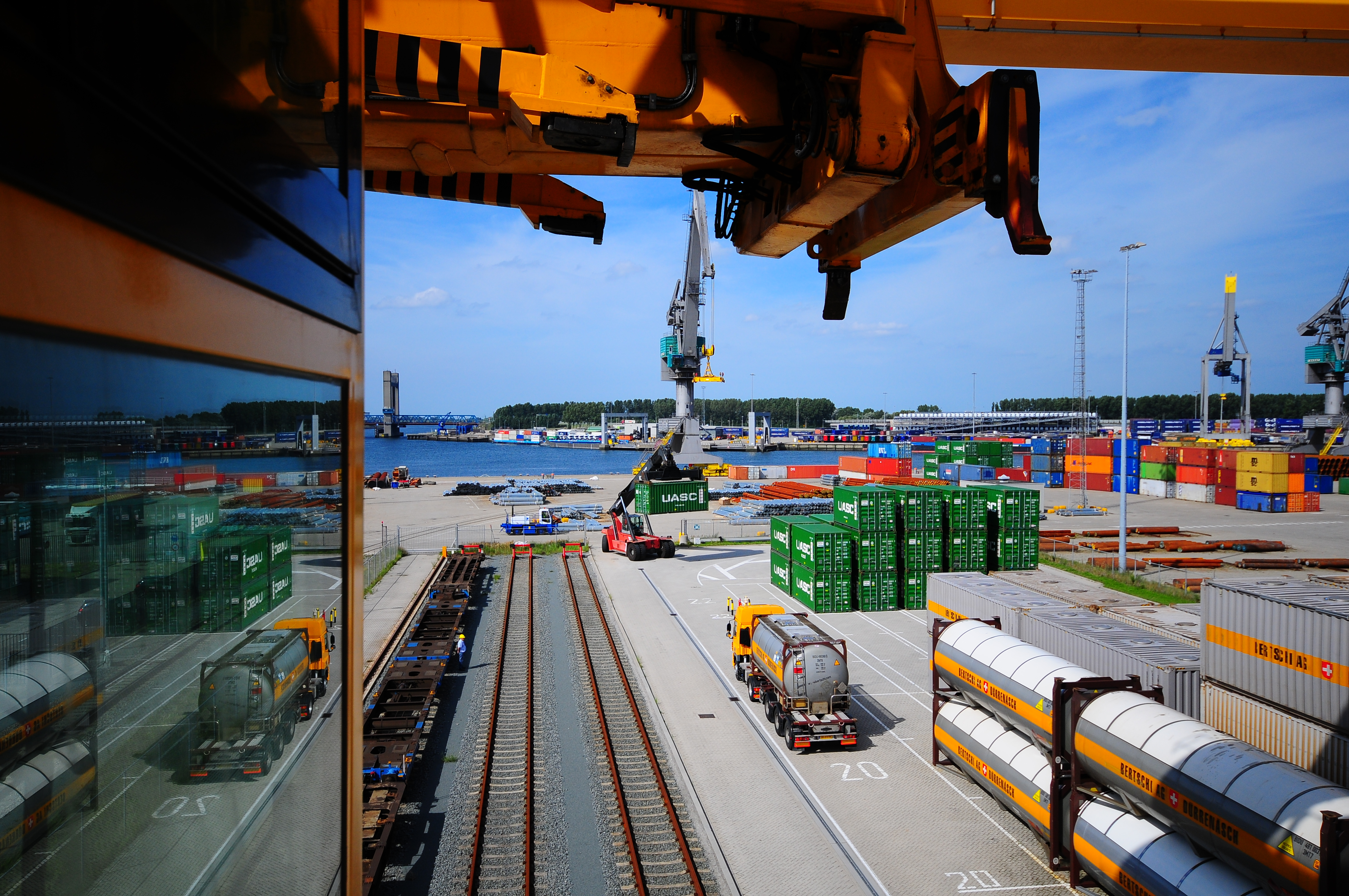 Bertschi port-side terminal with trucks, containers, and rail tracks