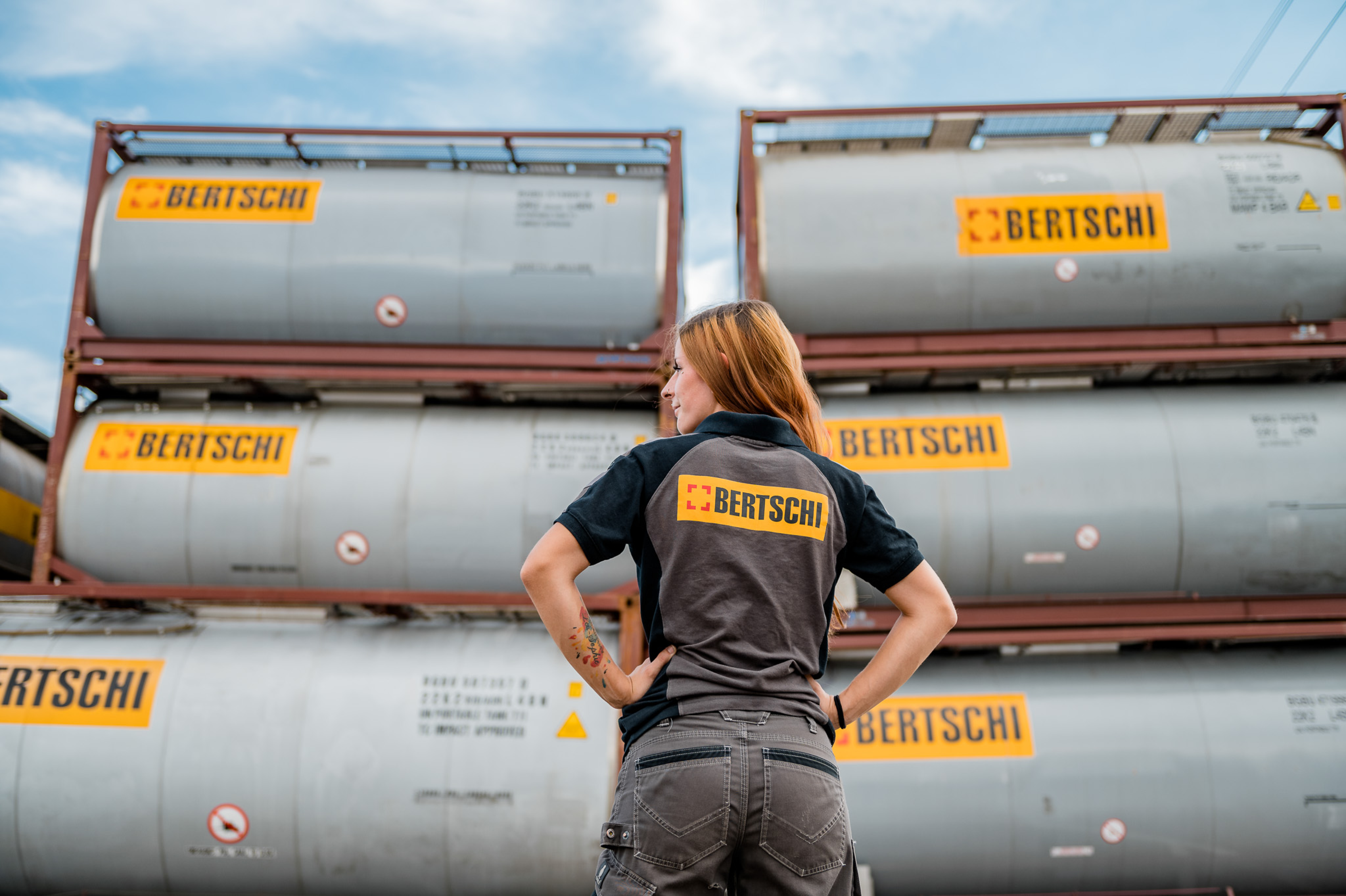 Bertschi female driver in front of container pile
