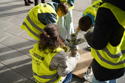 Children working on some mechanical parts outside  