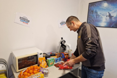 man standing infront of a table with food 