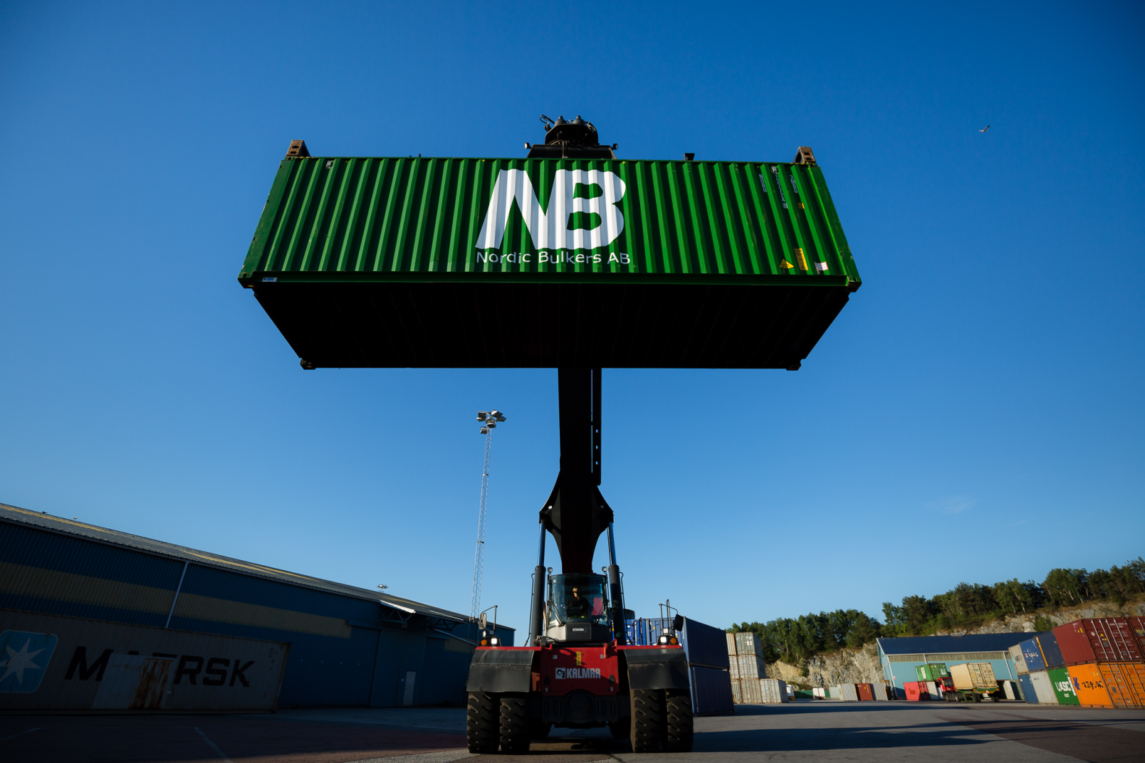 Reach Stacker holding Nordic Bulkers Container