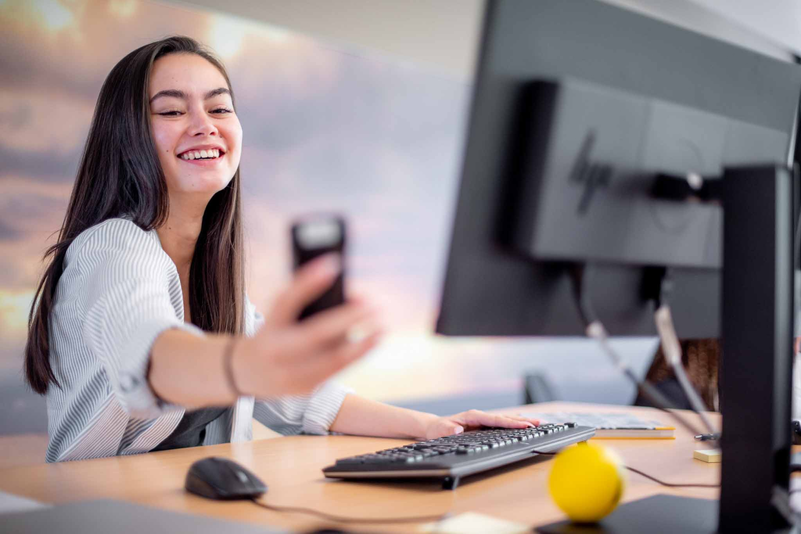 woman holding phone and smiling