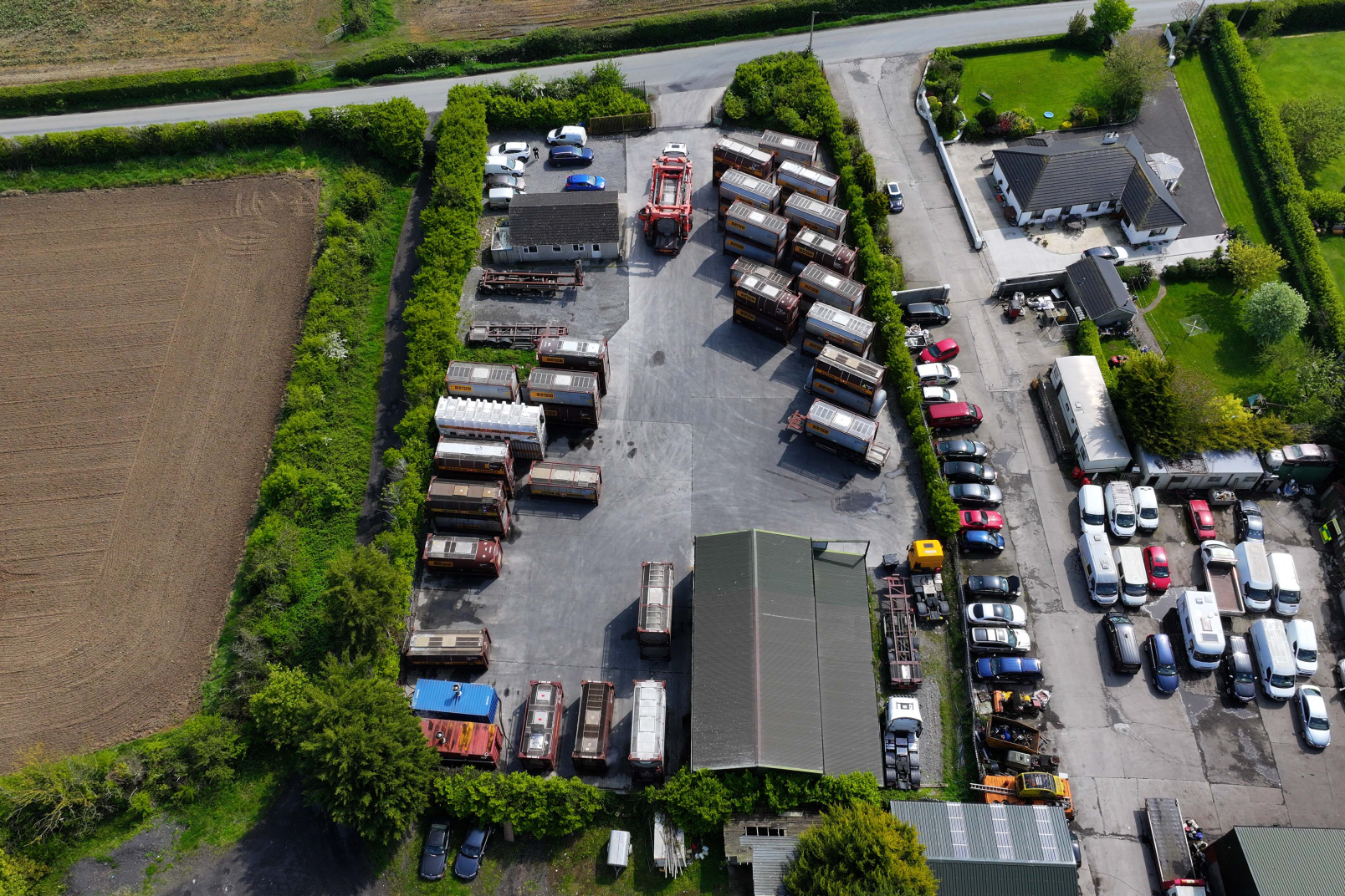 Picture made from the sky with a drone down to the trucks and containers