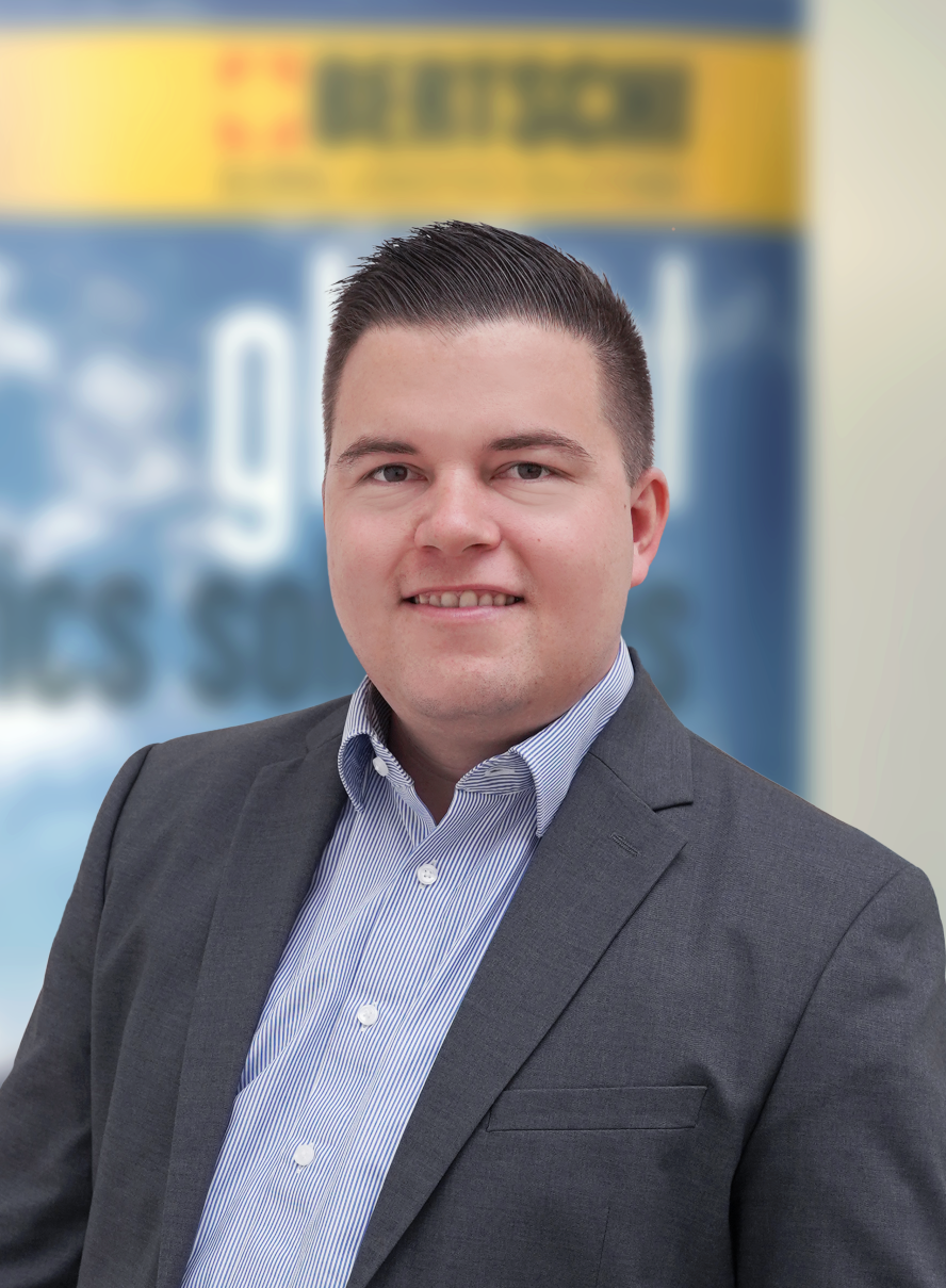 Corporate photo of Gian Bühlmann, male, in a dark gray suit